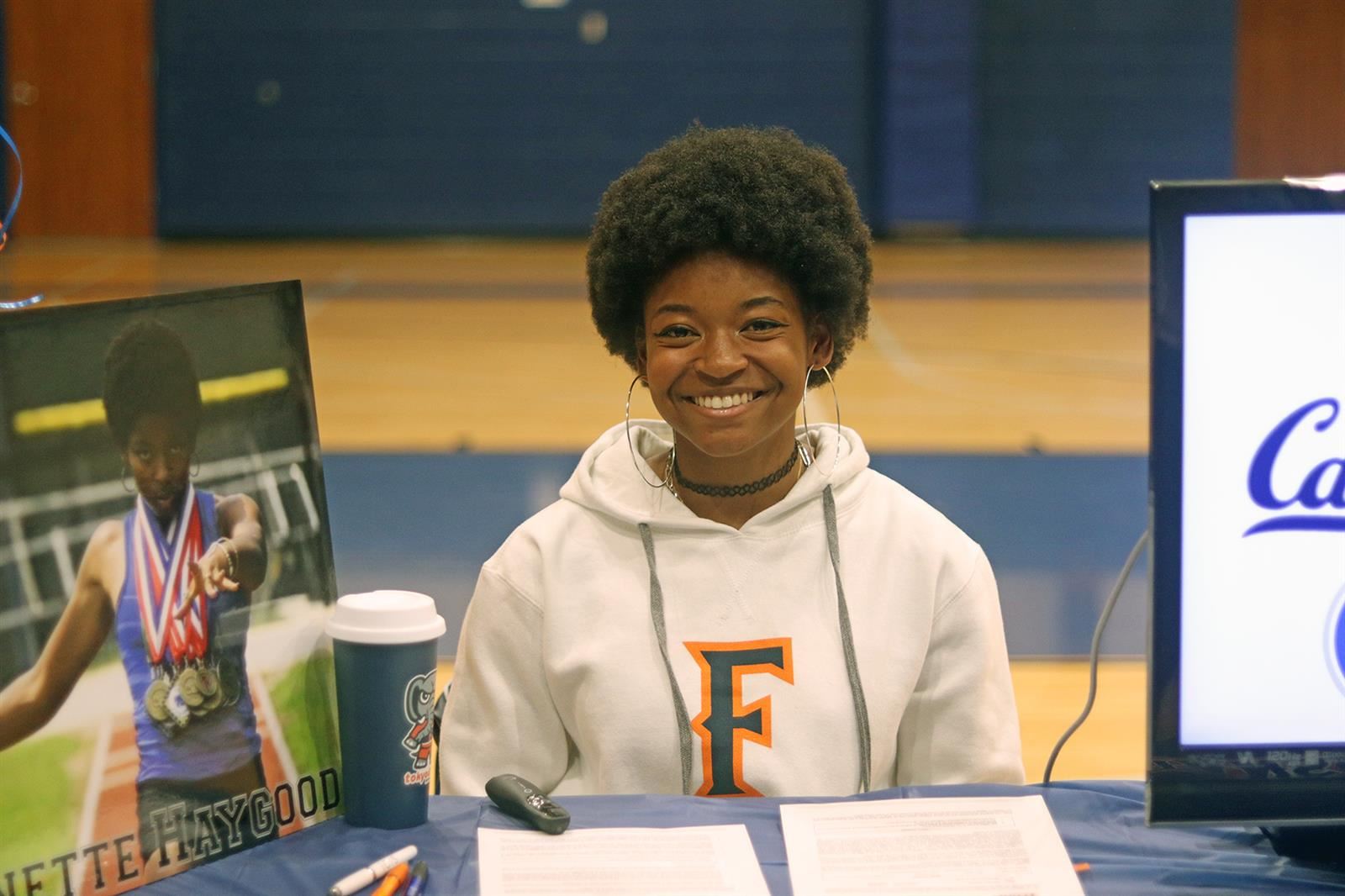 Cy Creek senior Dannette Haygood smiles after signing a letter of intent to California State University, Fullerton.